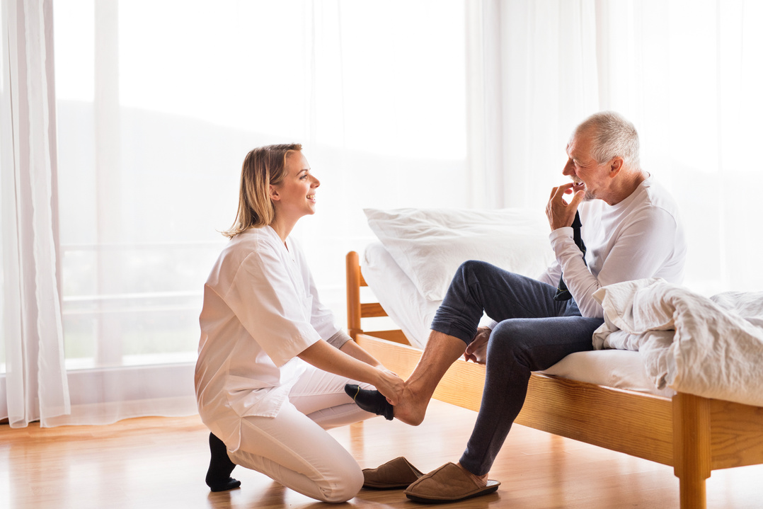 Health Visitor and Senior Man during Home Visit